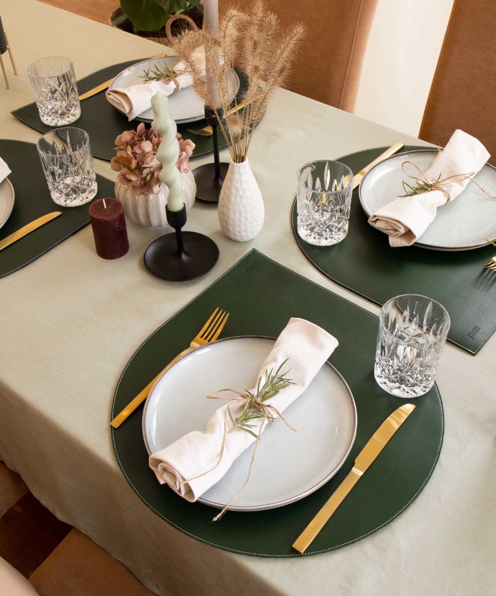 Vegan sustainable placemats in emerald green laying on a table, by nuuwai